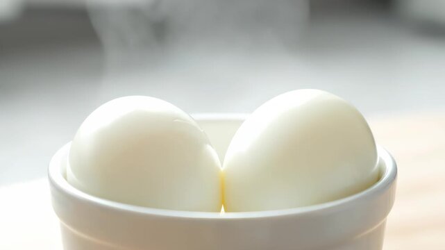 Close-up of eggs in a bowl, steaming hot poached eggs