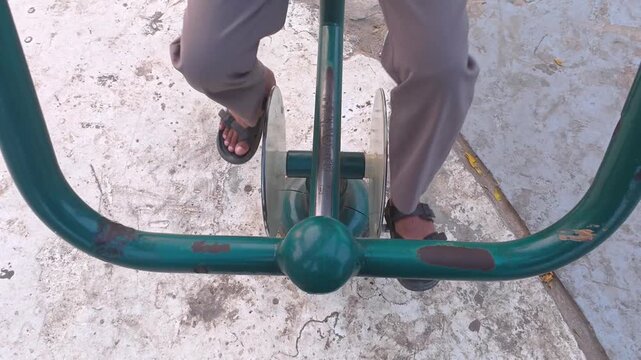 High angle shot of person exercising on outdoor fitness gym equipment
