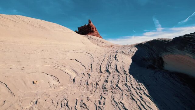 Drone aerial of rock striations and sandstone butte in Grand Staircase Escalante National Monument, Utah.