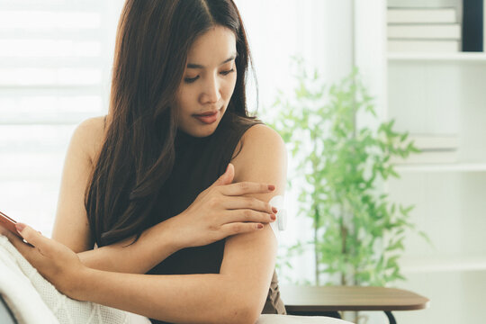 Woman Checking Blood Glucose Level During Telehealth Consultation at Home