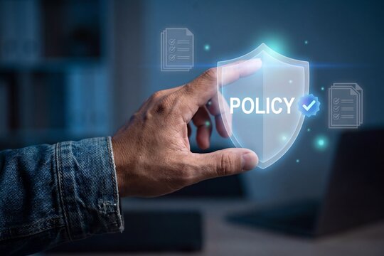 Policy management security framework, hand pointing at holographic shield with policy text and verification badge, compliance documents, data protection, governance enforcement and regulatory control