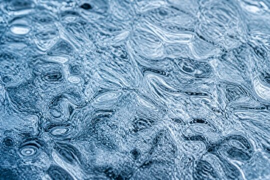 Textured ice surface showing ripples and frozen water patterns