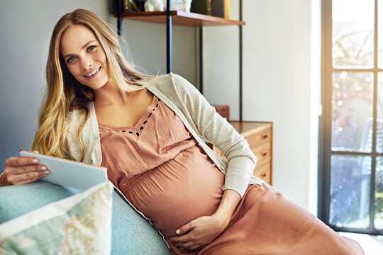 Happy, portrait and pregnant woman with tablet in lounge, relax and research parenting tips in home. Search, online and person with tech, chilling and pregnancy tracker for fetal development in house
