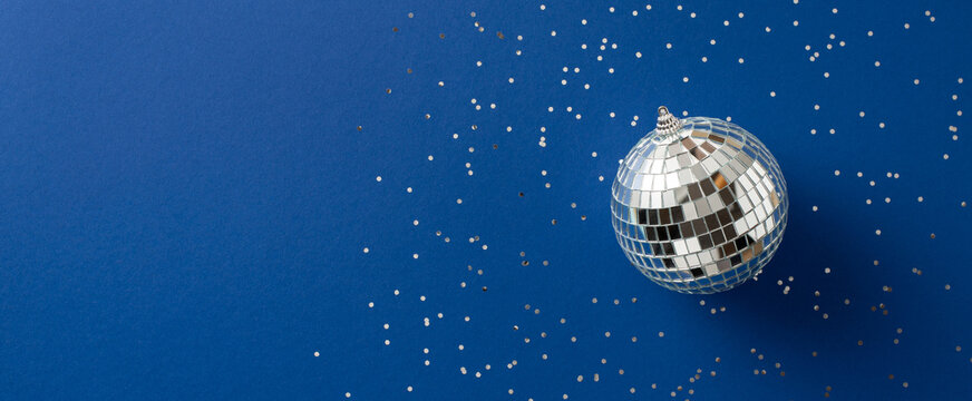 Merry Christmas and happy New Year scene with Santa Claus disco ball ornament and shimmering confetti