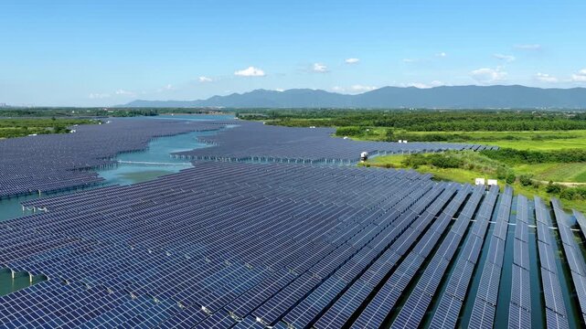 Panoramic view of floating solar power station on water with distant mountains