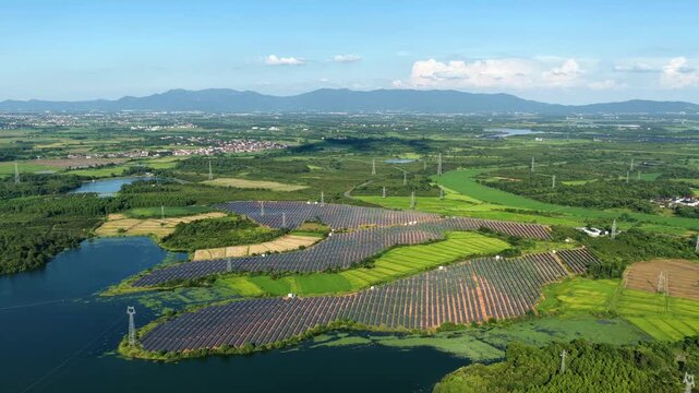Large scale solar panel array installed on green farmland fields