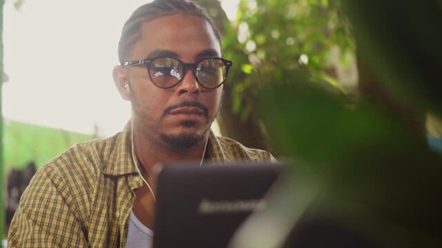 Focused male entrepreneur working on laptop in cafe
