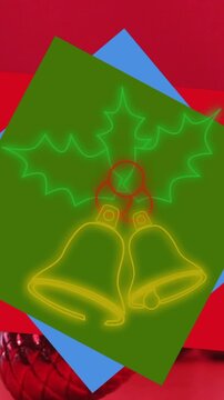 Animation of neon christmas bell icon over party popper and christmas gifts against red background