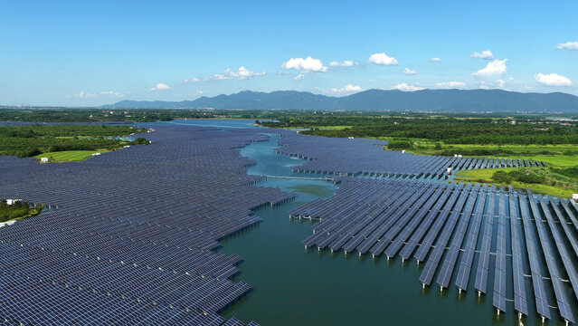 Aerial view of large floating solar power station on lake water