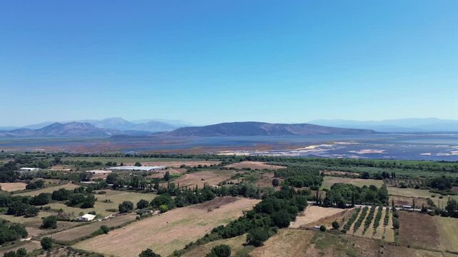 Slow motion drone shot panning to the right showing the scenic rural landscape and wetlands of Tsopeli Lagoon near Preveza.