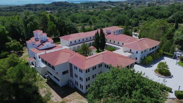 Establishing drone shot showcasing the beautiful architecture of Prophet Elias Christian Orthodox monastery in Flamboura near Preveza.