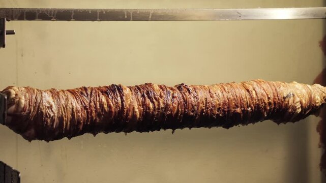 Traditional Turkish kokorec made from lamb intestines tightly wrapped around a spit before grilling. Authentic street food preparation and Turkish culinary tradition. High quality 4k footage