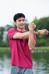 Man stretching arm before outdoor workout