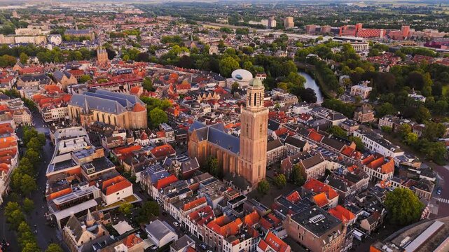 Golden-hour drone view over Zwolle&rsquo;s historic center with the Peperbus, Grote Kerk, red rooftops, green canals and surrounding neighborhoods in the Netherlands.