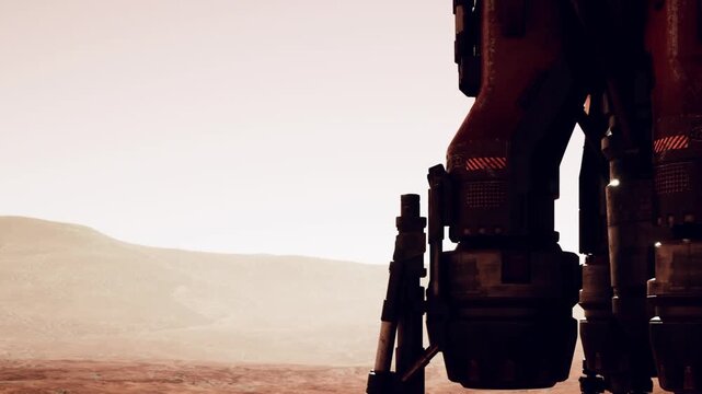 A robotic structure stands on the surface of Mars. The background shows a distant landscape with hills and valleys. The setting sun casts a warm light over the scene.