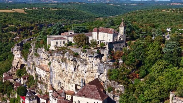 Drone gently descends and pulls back from Rocamadour sanctuary and cliffside