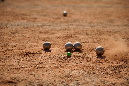 Petanque Boules and Green Cochonnet Target Jack on Ground Action Shot