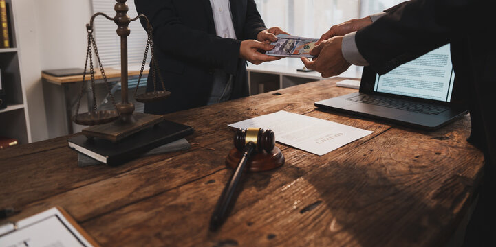 Businessmen exchanging money, representing bribery and corruption in legal system
