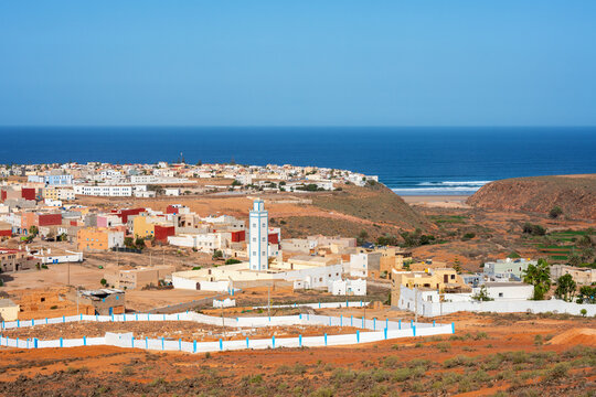 Mirleft town and mosque overlooking ocean coastline in Morocco