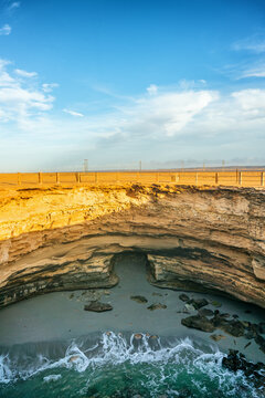 Trou Ajeb Law natural sinkhole and beach with waves