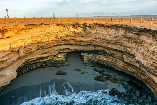 Trou Ajeb Law natural sinkhole and beach with waves