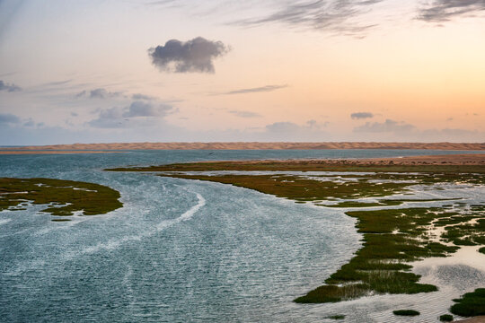 Khnifiss National Park lagoon wetlands sand dunes at sunset, Morocco