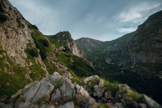 Rugged mountain trail winds through lush green slopes in the Tatras