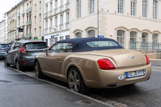 Nancy, France - July 27th 2019 : View on a beige Bentley Continental GTC parked on a street.