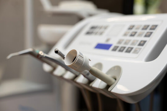 Side angle view of dental delivery unit and control panel