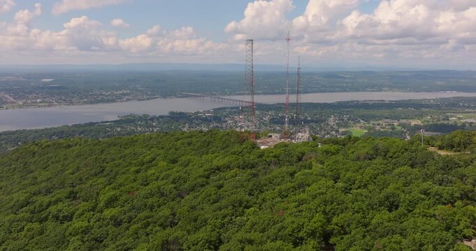 Radio Towers fly around on Mount Beacon in New York show valley and Hudson River with Newburgh Beacon Bridge