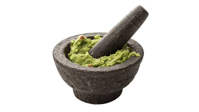 Traditional dark stone mortar and pestle filled with fresh guacamole isolated on transparent background