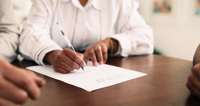 Senior, couple and hands sign paperwork in meeting with approval, last will and testament agreement. Pensioner, married people and signature on document for retirement planning, trust or inheritance.