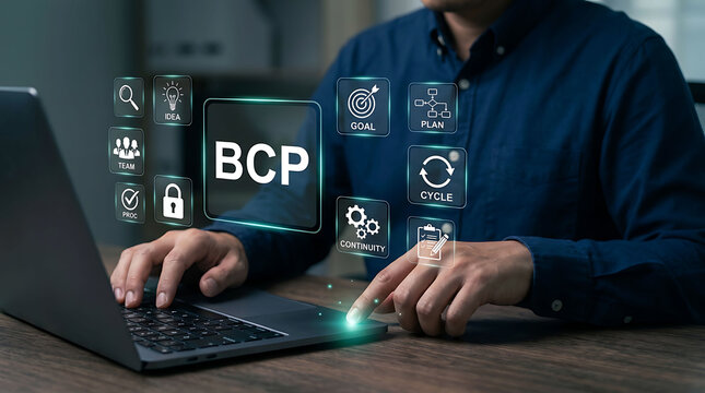 Businessman working on laptop with virtual BCP and business icons floating