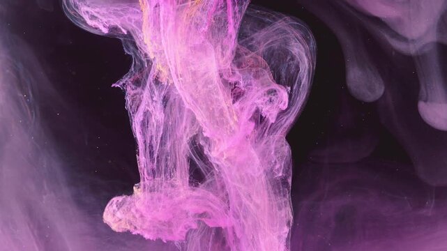 Dense vertical column of pink and magenta pigment disperses into near-black liquid, fragmenting into curls, wisps, and translucent sheet-like veils, brighter magenta