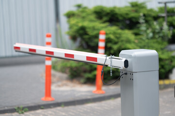 Closed security barrier arm blocks entry to a restricted parking area during the daytime © Jam