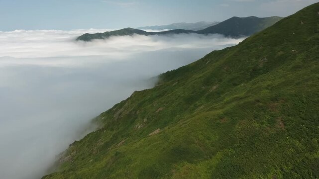 Aerial View of Mountain Ridge Above Sea of Clouds at Dawn