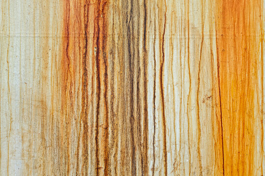 Dirty white wall background with dramatic vertical steel rust streaks and textured time deterioration patterns.