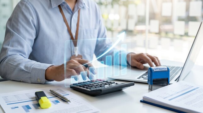 Person using calculator with chart and laptop at office desk with person sitting statistics documents business analysis finance graph paper with work