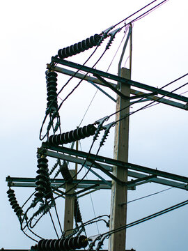 High Voltage Power Line Insulators Silhouetted Against Overcast Sky