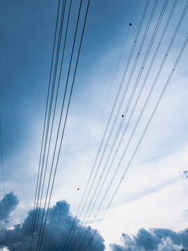 Power Lines Against Dramatic Cloudy Sky Minimal Blue Sky Background