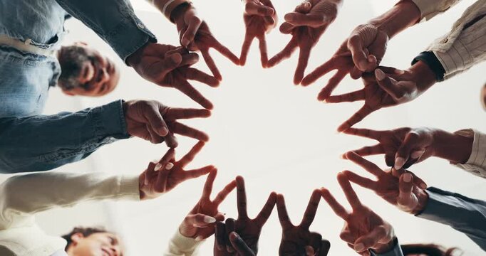 Below, fingers and huddle with business people in circle together for connection or solidarity. Collaboration, diversity and support with happy employee group in unity for development or synergy