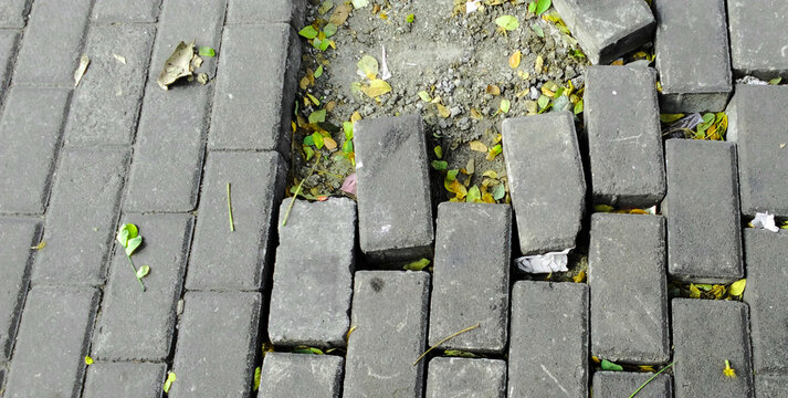 Damaged paving block pedestrian path