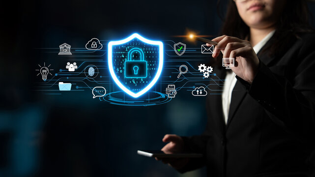 Businesswoman Interacting with Digital Shield Icon for Cybersecurity and Data Protection in Modern Office Environment. Entropy.