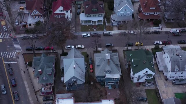 Aerial view of urban neighborhood construction site and residential suburban homes with train tracks.