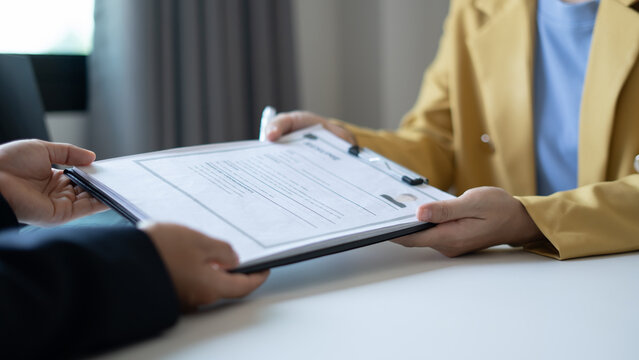 Business people hold a resume and talk to job applicants for job interviews about careers and Their personal history in the company. Recruitment concepts