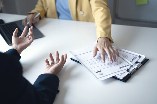 Business people hold a resume and talk to job applicants for job interviews about careers and Their personal history in the company. Recruitment concepts