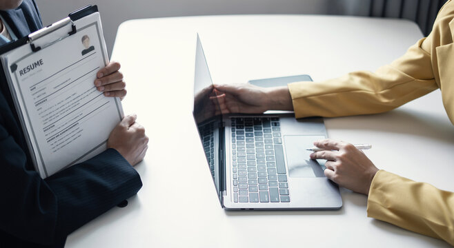 Business people hold a resume and talk to job applicants for job interviews about careers and Their personal history in the company. Recruitment concepts