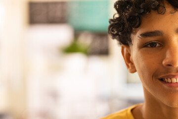 Smiling teenage boy focusing on classroom activities in high school, copy space © WavebreakMediaMicro