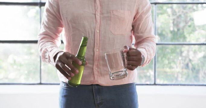 Lifestyle videos indoor of people doing activities at office, pouring beer from bottle into glass mu