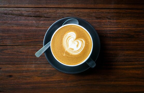 dessert, cappuccino, breakfast, coffee, cup, drink, tea, cafe, white, food, beverage, hot, brown, espresso, caffeine, saucer, table, chocolate, mug, plate, spoon, morning, milk, black, mocha